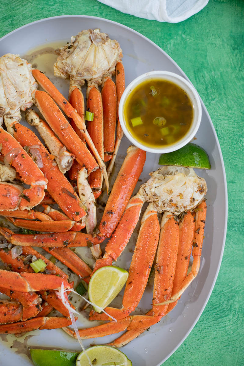 Caribbean-style baked jerk crab legs served with lime wedges