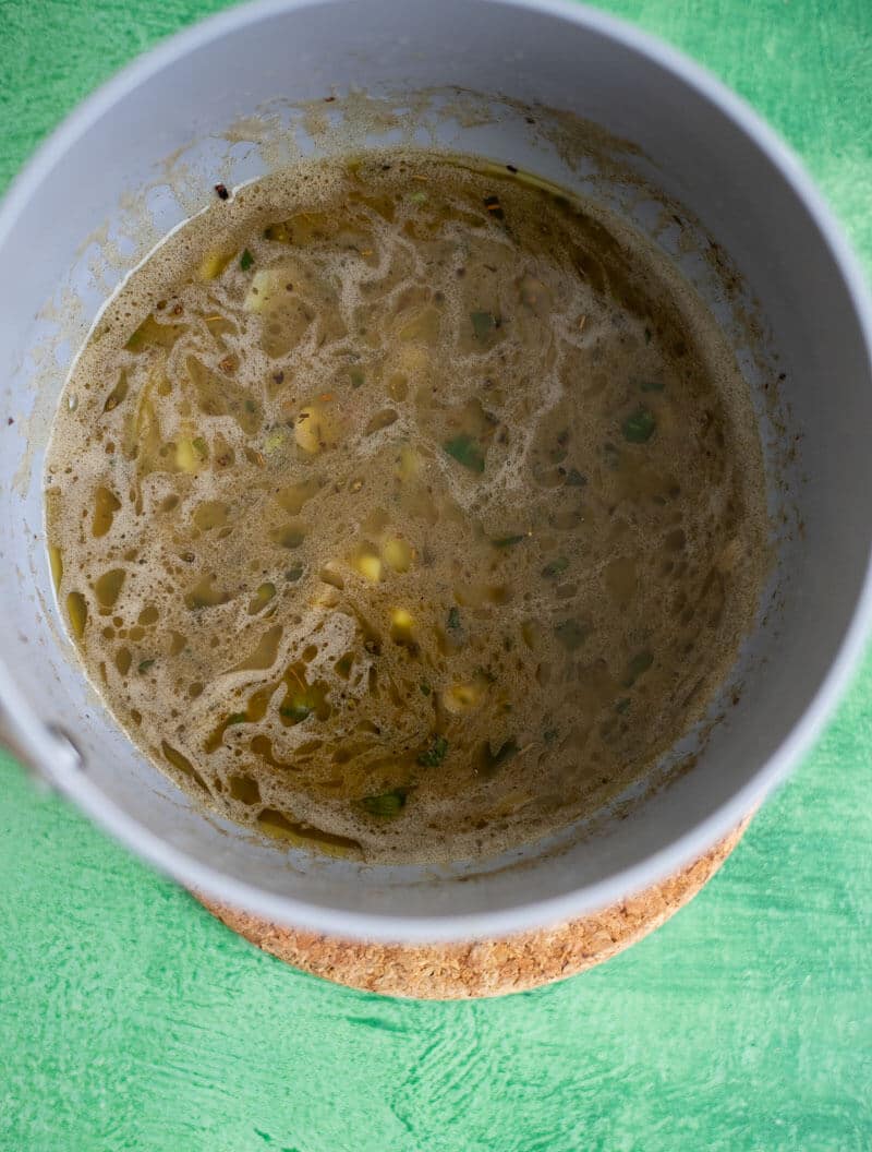Garlic butter jerk sauce simmering in a saucepan.