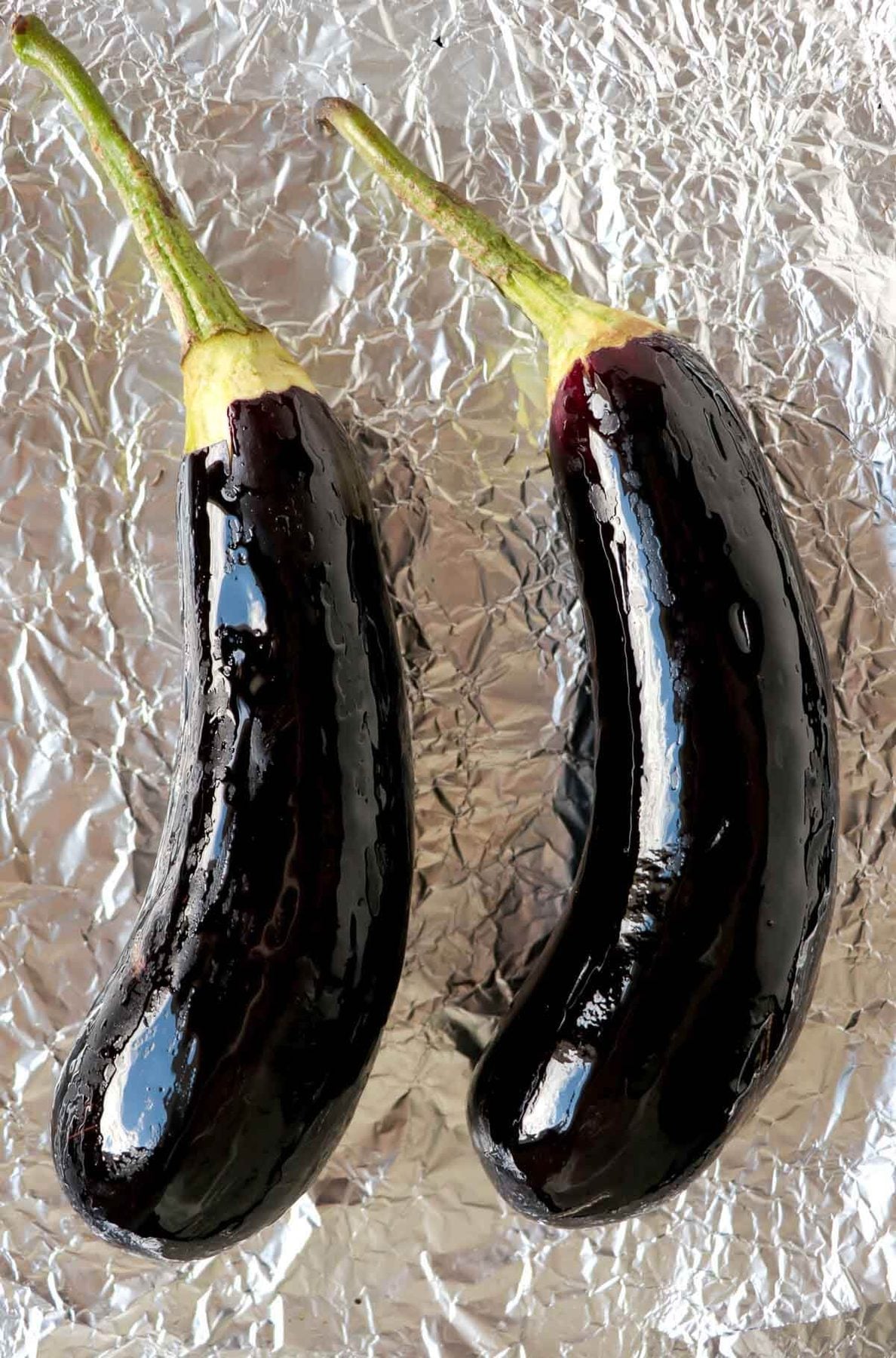 Baigan choka is a Caribbean vegetarian dish that is robustly flavored with garlic and roasted. This mashed treat is best served with roti or rice . eggplants oiled and ready to be roasted.