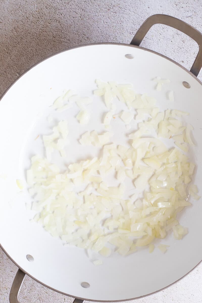Chopped onions sautéing in a pan as the base.