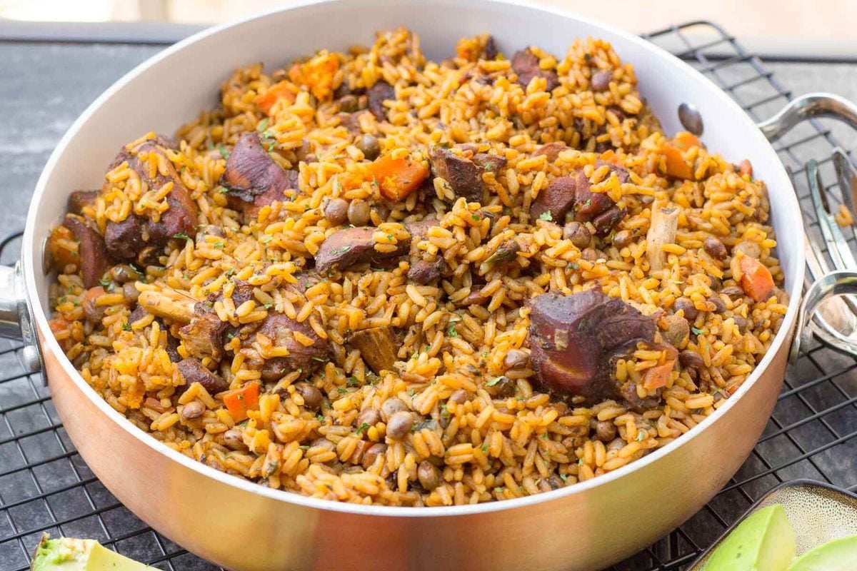 Learn how to make Trinidad’s unofficial national dish, pelau—a hearty one-pot meal with caramelized chicken, rice, and pigeon peas. This step-by-step guide makes it easy! Pot of Trinidad chicken pelau with pigeon peas and rice