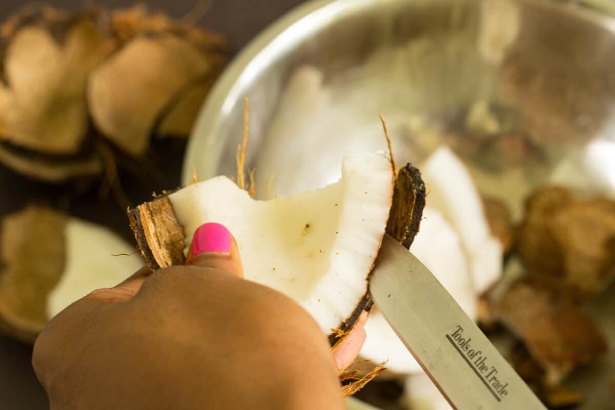 An easy step by step guide for making coconut milk from a fresh dry coconut just like we do it in the Caribbean. Removing coconut meat from the shell using a knife.