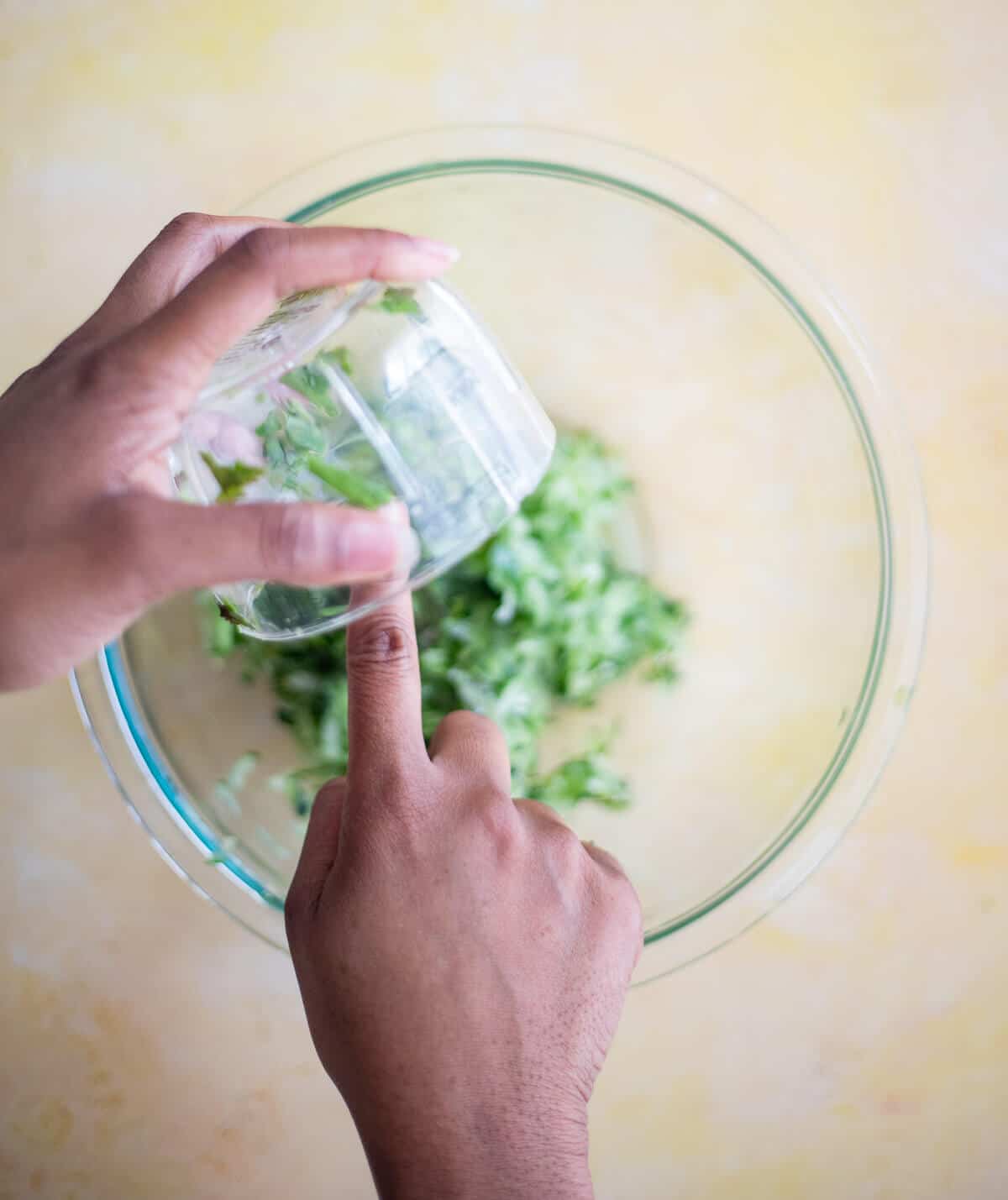 Adding blended seasoning to grated cucumber for chutney