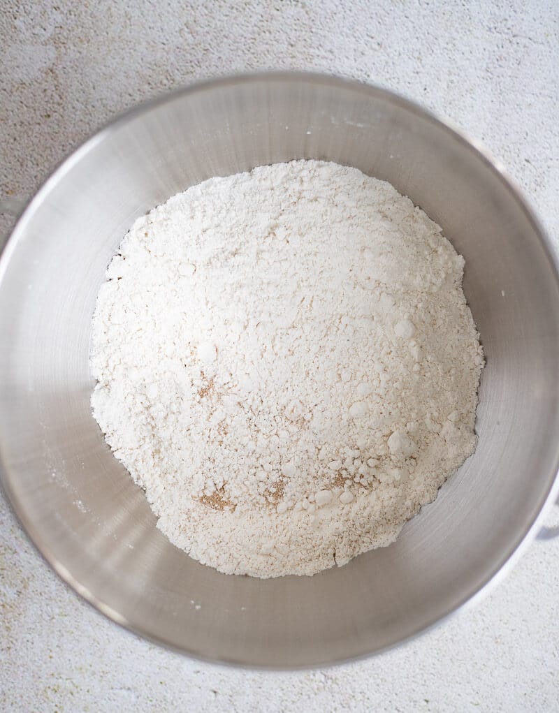 Flour, yeast, sugar, and salt combined in a bowl.