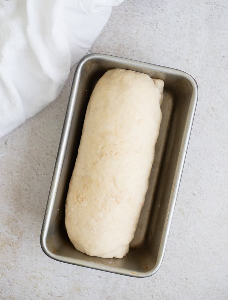 Dough rising in loaf pan during the second rise .