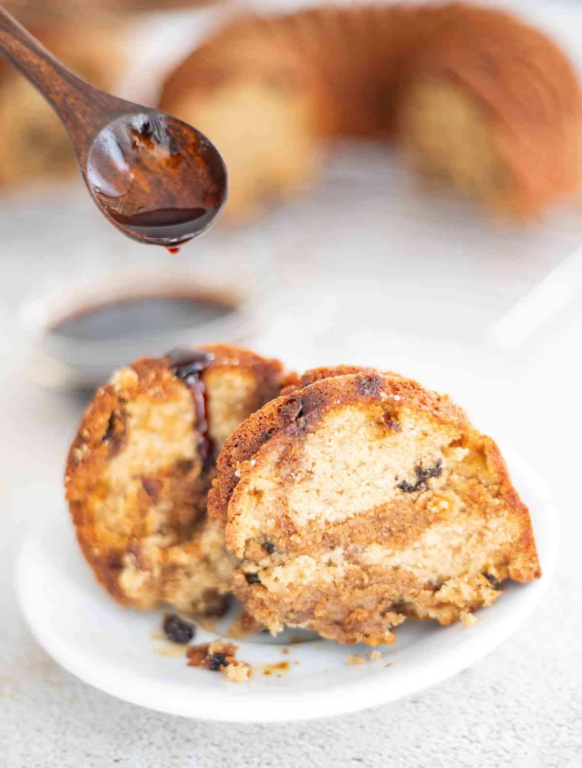A light sponge cake with fruits soaked in Don Q Anejo. A delicious cake perfect for the Christmas season. #homemadezagat #Exceptional #DonQRum #ad Rum being drizzled over slices of Caribbean fruit sponge cake, showing the dried fruits throughout the moist crumb.