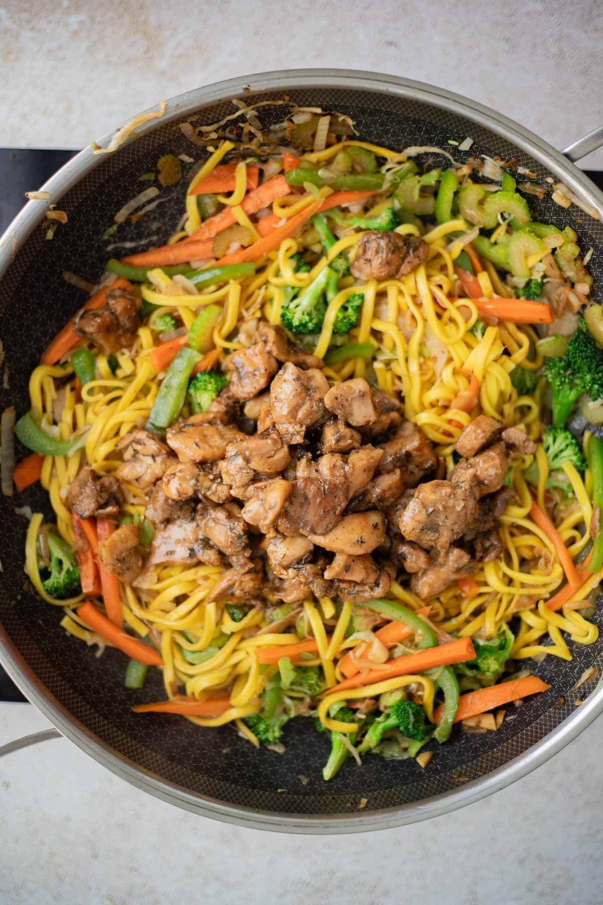 Cooked chicken added to the chow mein noodles and vegetables
