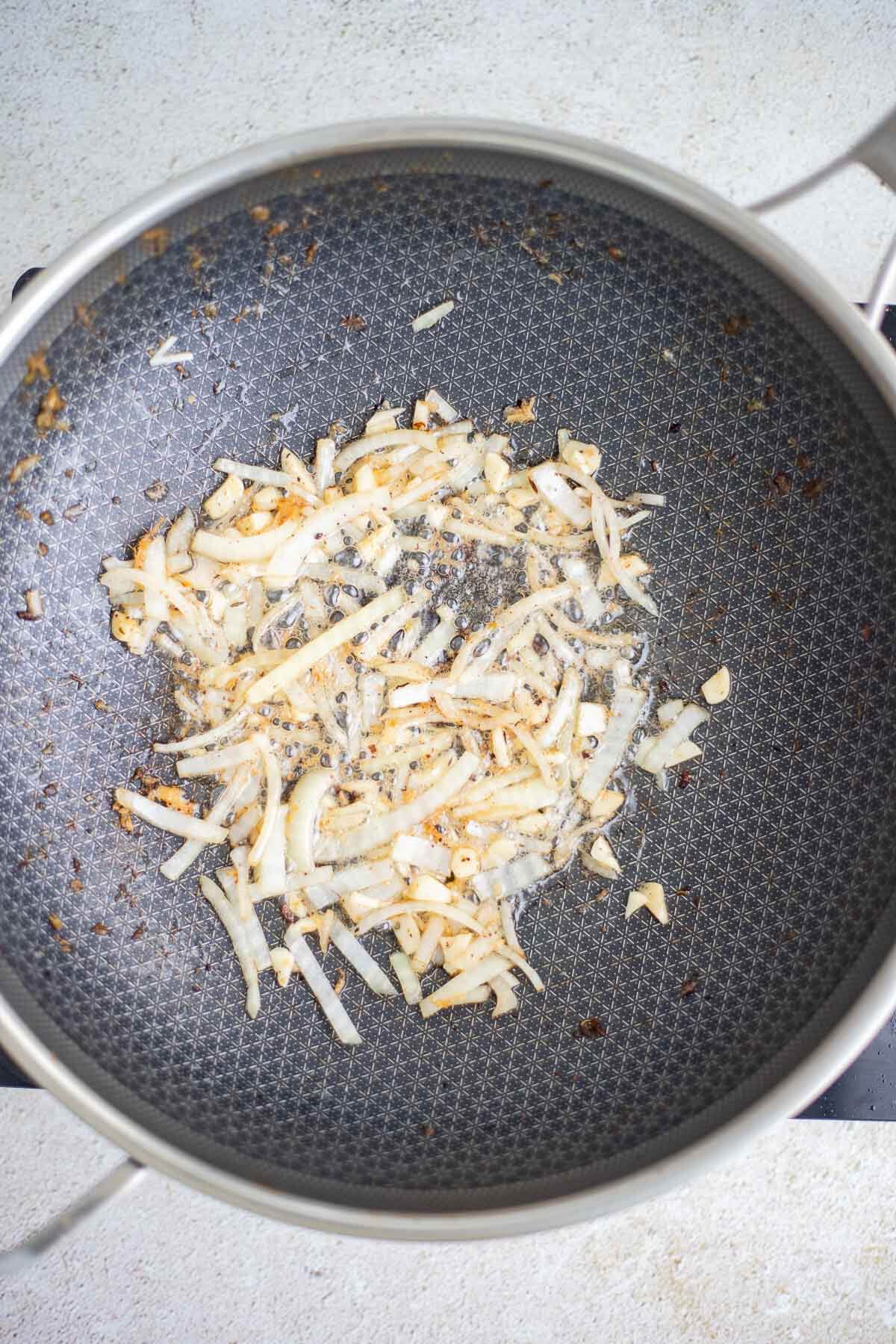 Onion, garlic and ginger sautéing for Caribbean chow mein