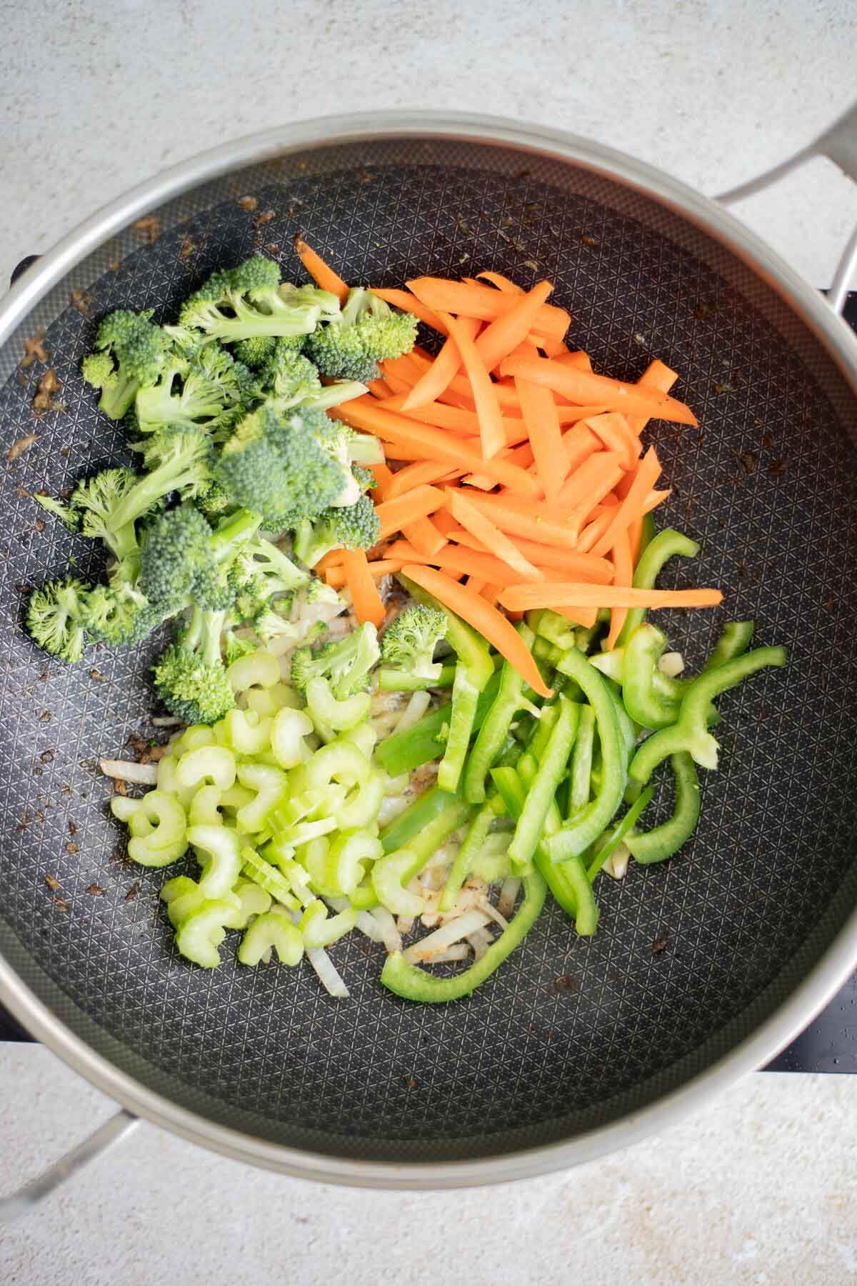 Carrots, broccoli, celery and peppers stir-frying for chow mein