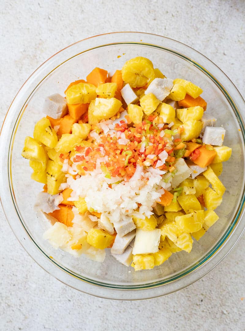 cubed cassava, plantain, dasheen and sweet potato with chopped onion and peppers