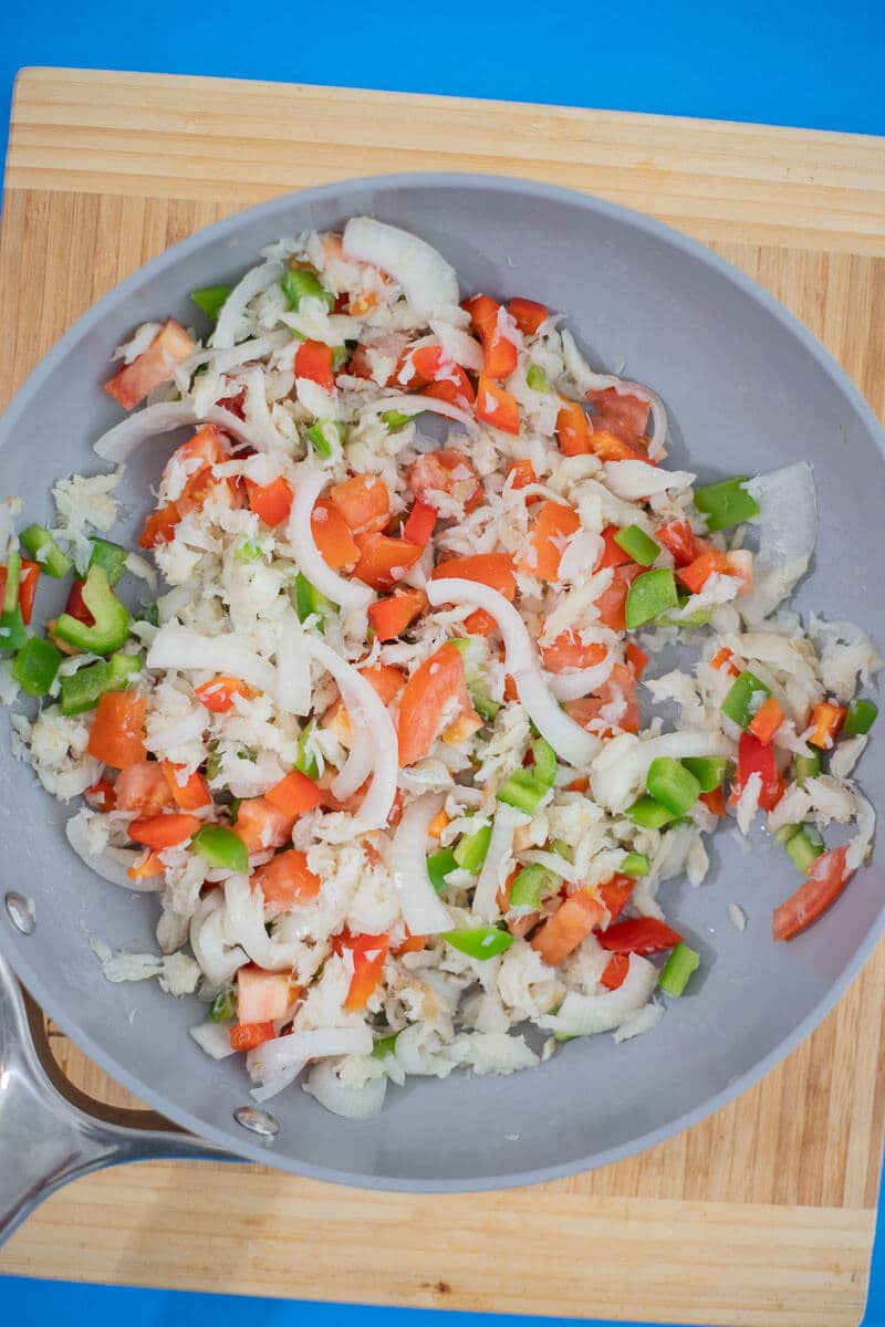 Sautéed saltfish with onions, peppers, scallions, and tomatoes for the pizza topping.