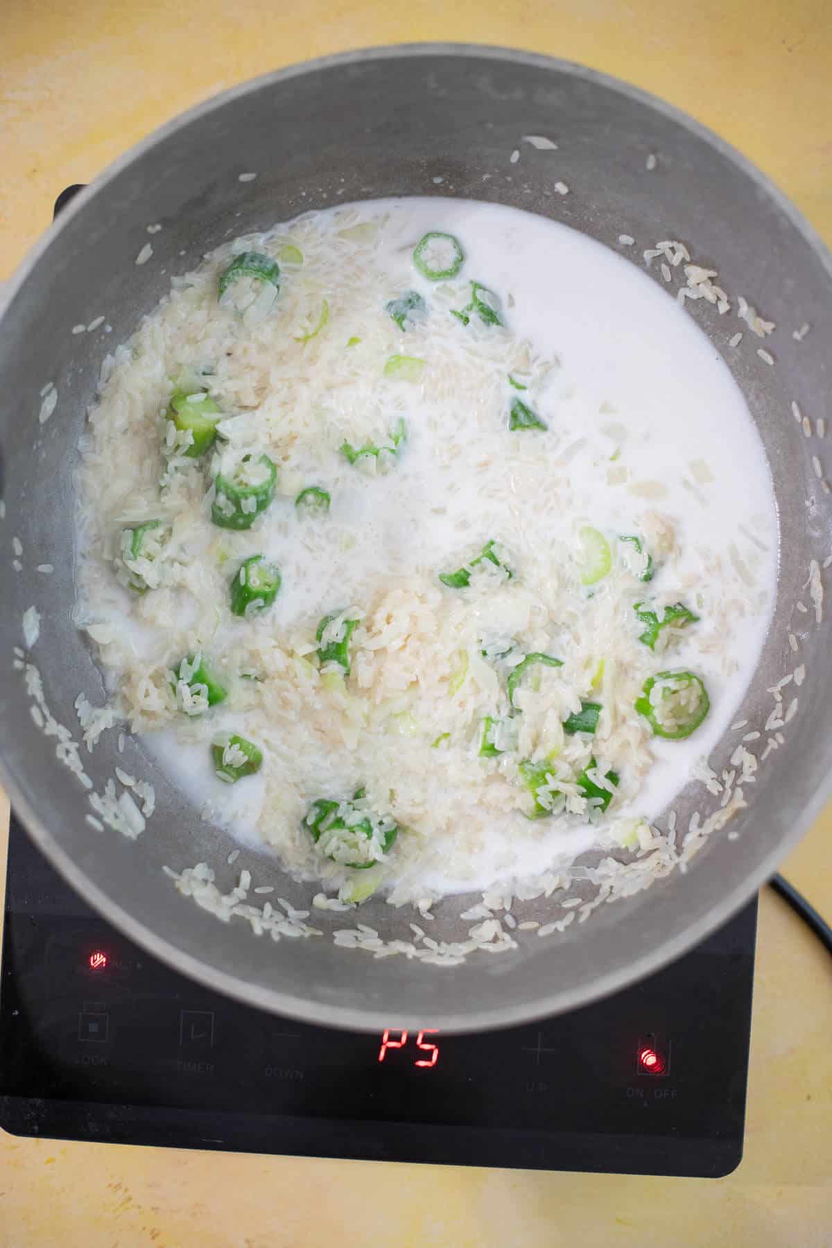 Coconut milk added to rice and ochro