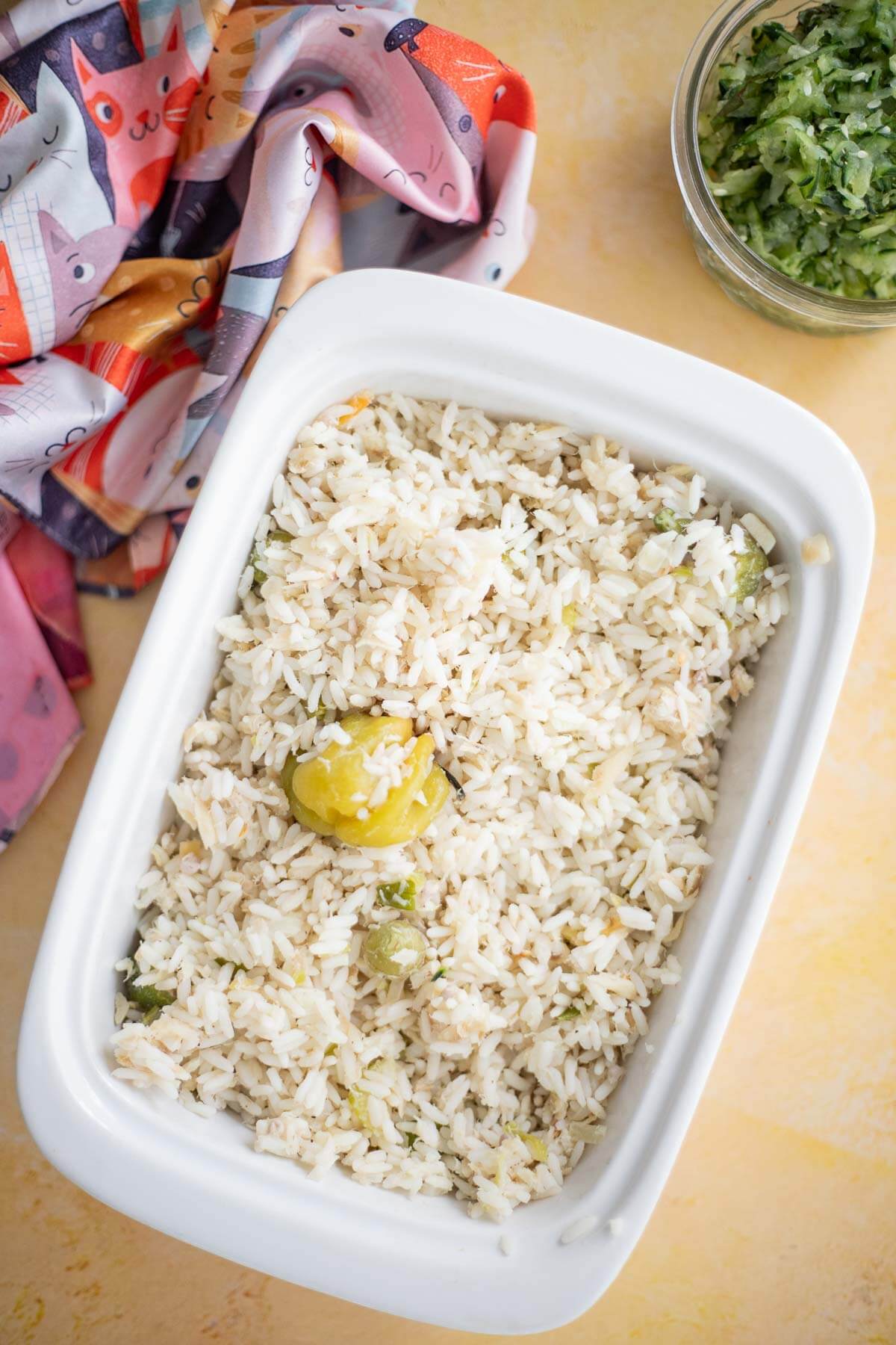 Cooked saltfish and rice with ochro and whole hot pepper