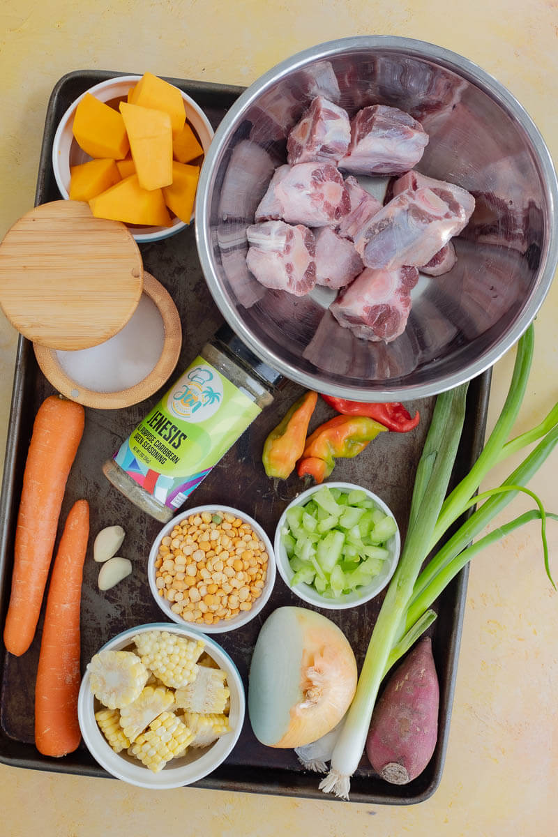 Ingredients including oxtail, split peas, pumpkin, corn, celery, onion, and seasonings