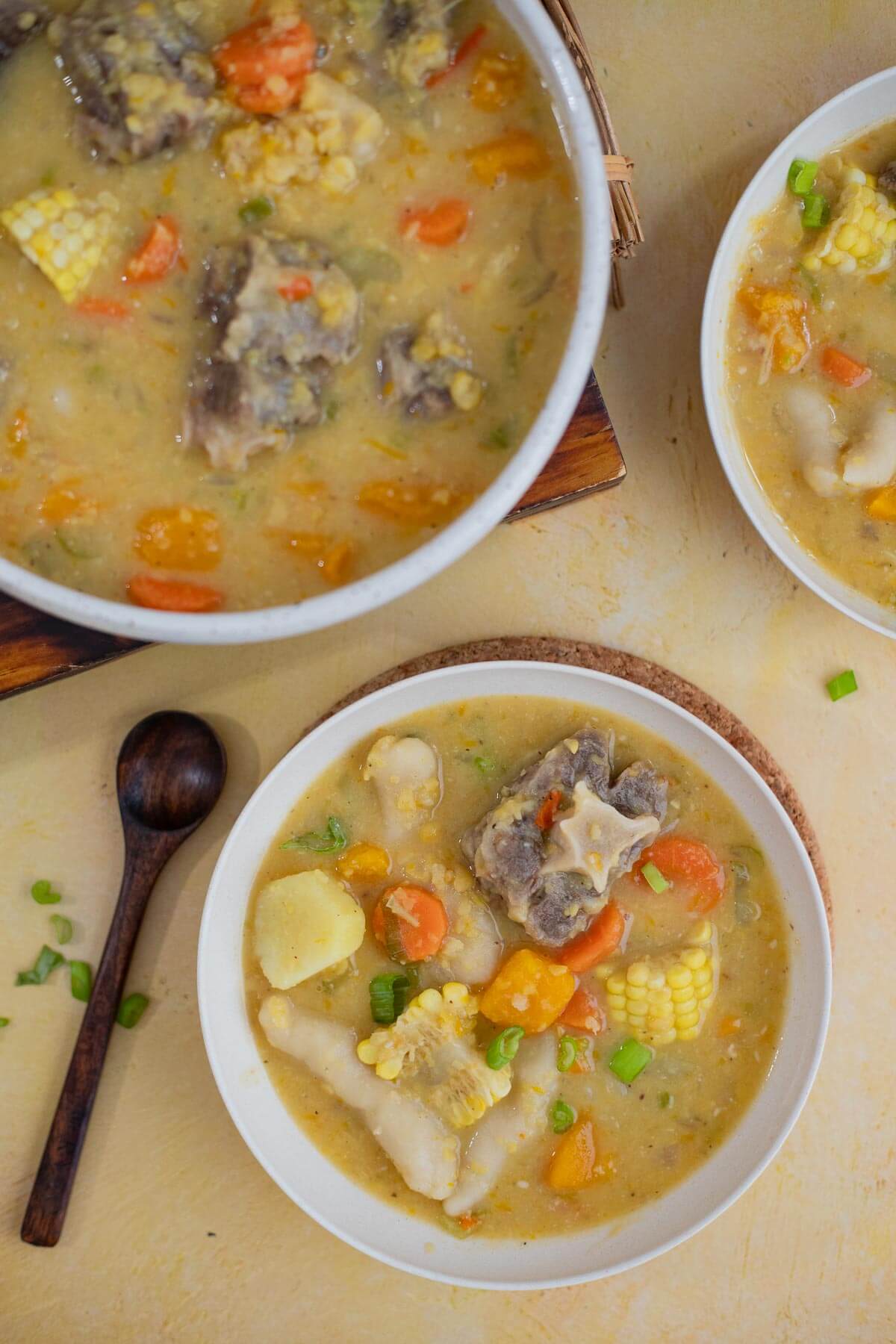 Hearty Caribbean oxtail soup with split peas, dumplings, corn, pumpkin, and tender oxtail.