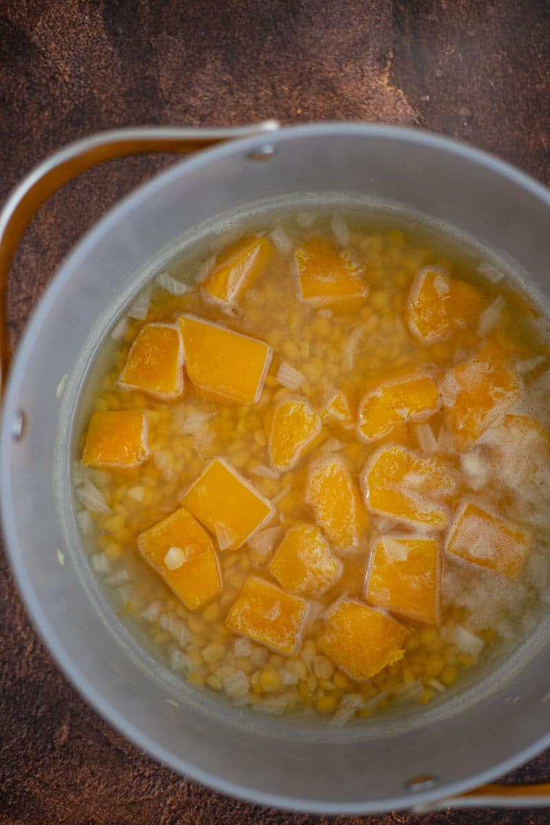 Pumpkin, split peas, onion and garlic cooking in water for the soup base