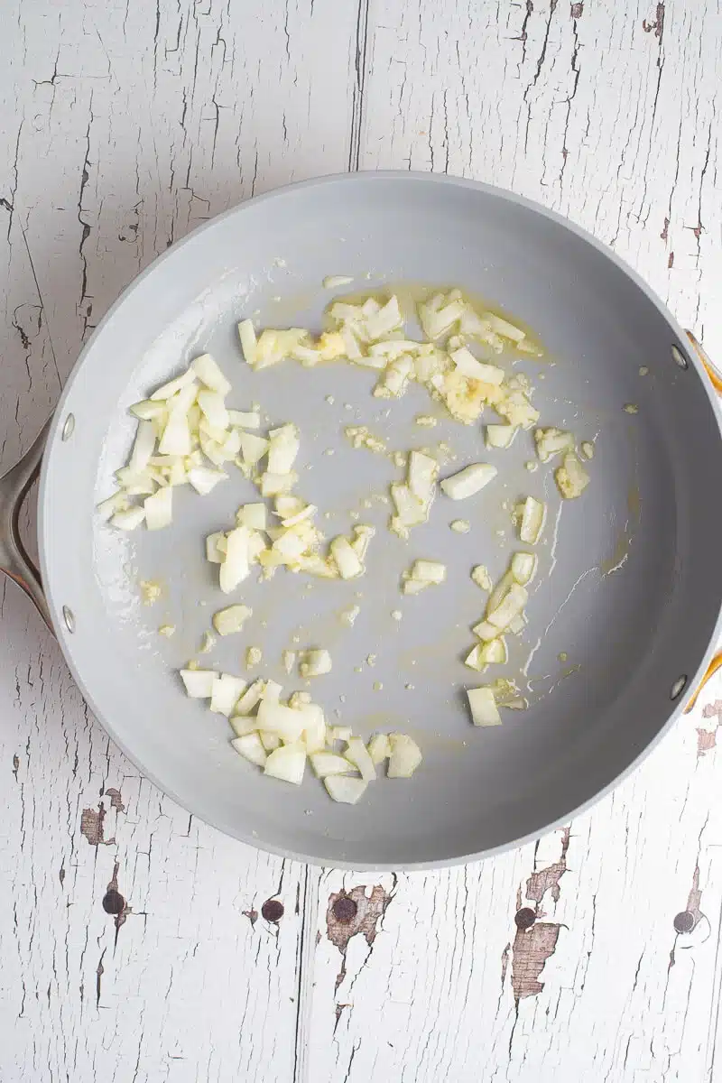 Chopped onion sautéing in melted butter
