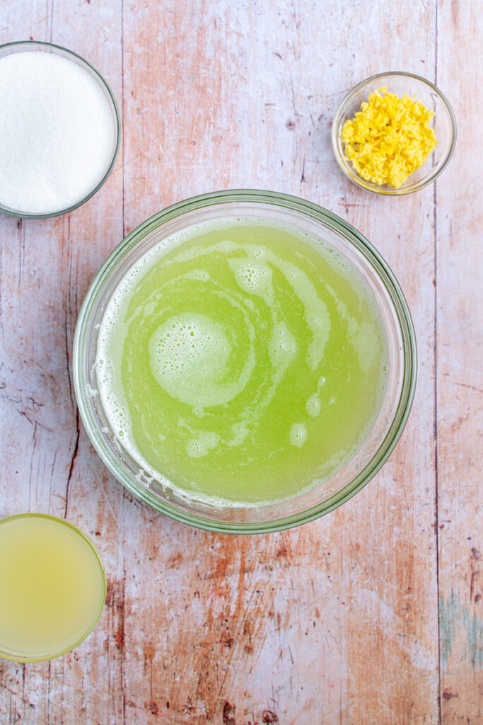 Cucumber and lime juice in a bowl getting ready to add lime and ginger.