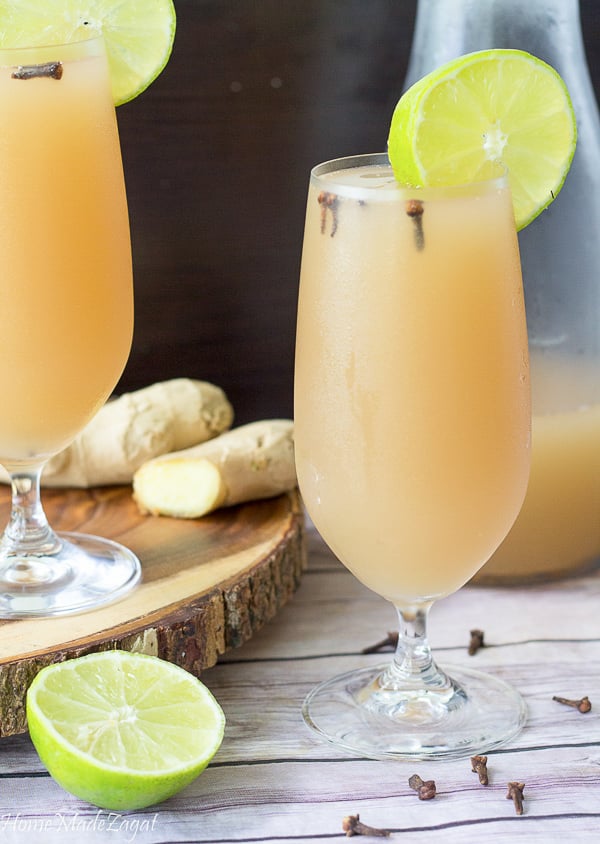 A tall, chilled glass of ginger beer with a slice of lime