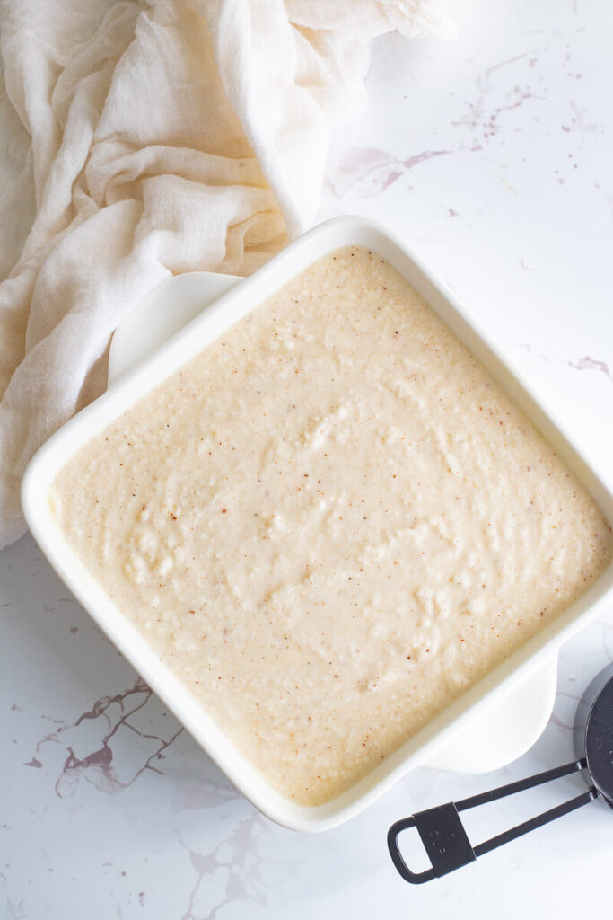 Mixed cassava pone in a baking dish prior to baking to show the consistency.