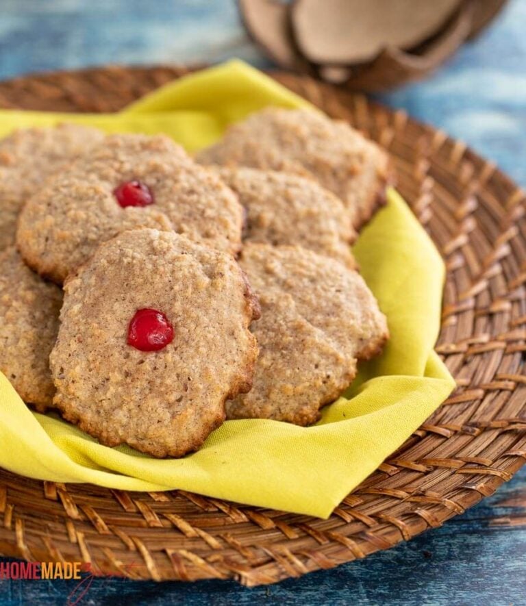A batch of baked Trinidad coconut drops with cherries on top.