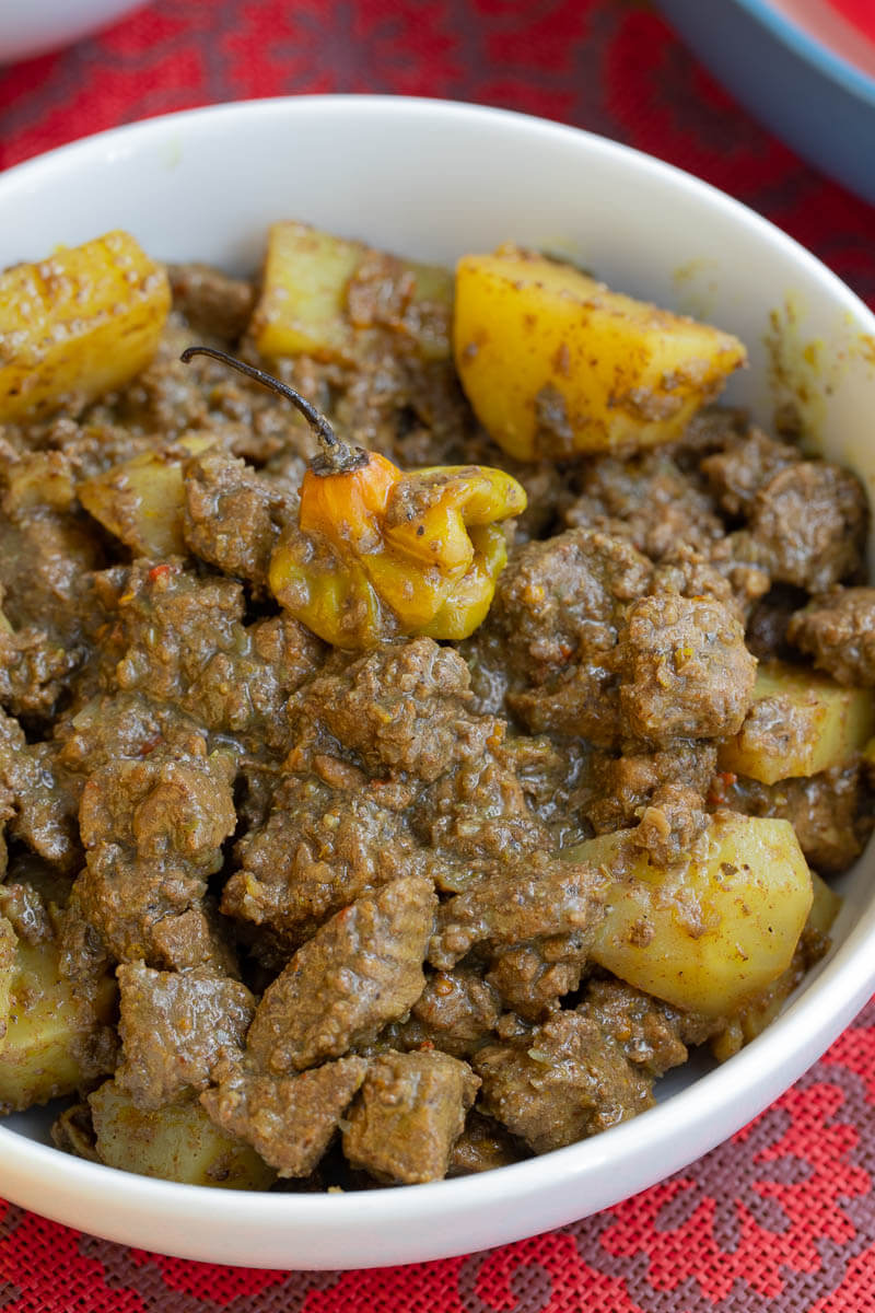 A white bowl of Caribbean lamb curry