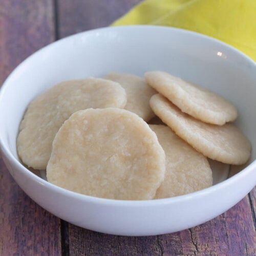 A picture of a white bowl of boiled cassava dumplings.
