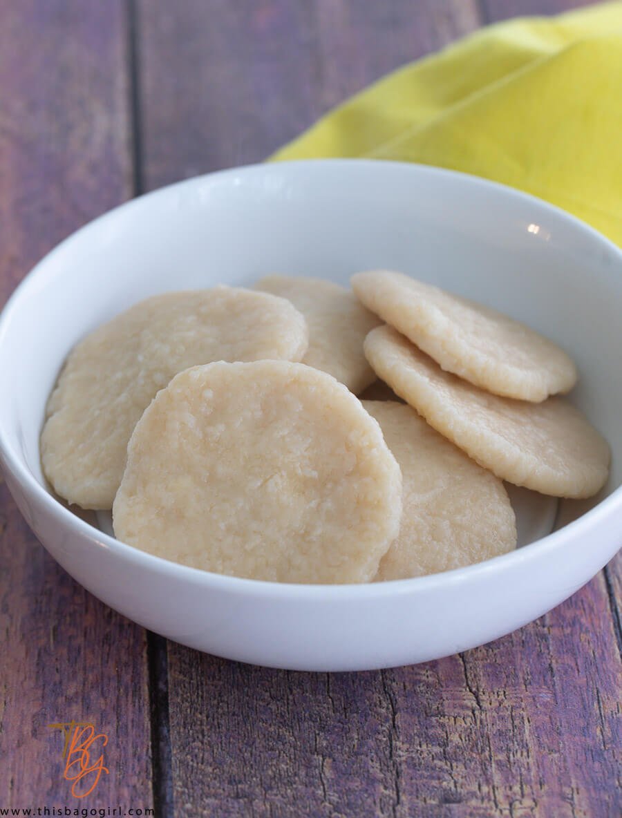 A picture of a white bowl of boiled cassava dumplings.