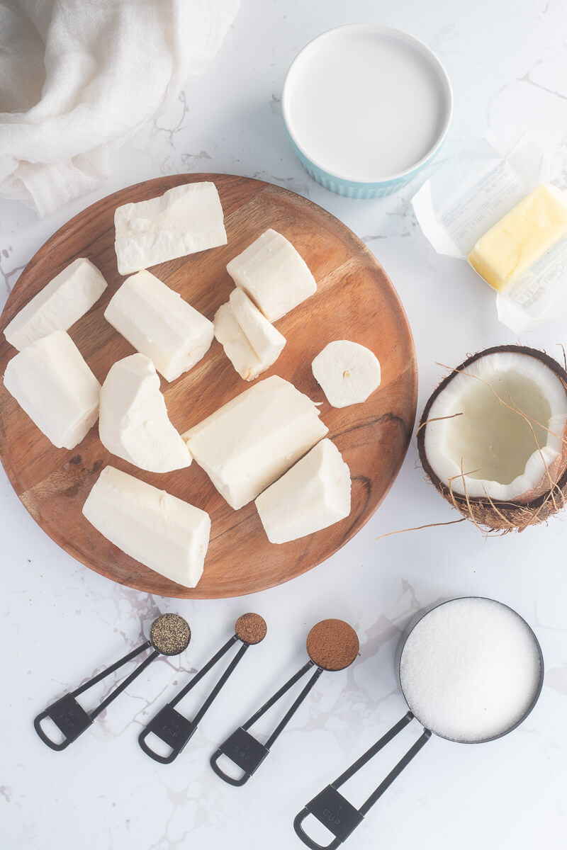 Ingredients for cassava pone on a brown plate on a white background.