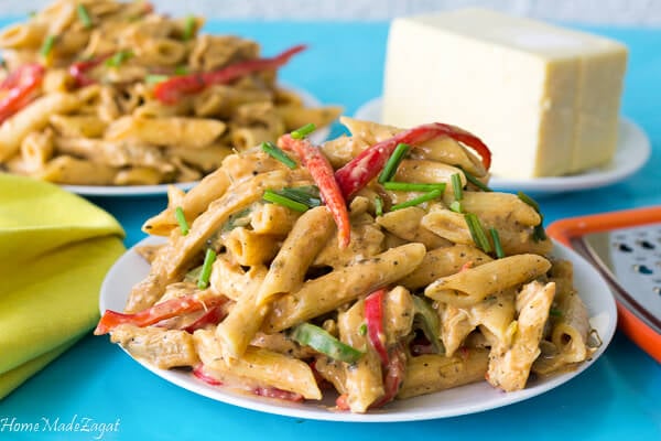 Plate of pasta and grater for extra cheese