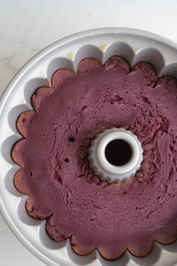 Baked sorrel cake cooling in pan on a white counter top.