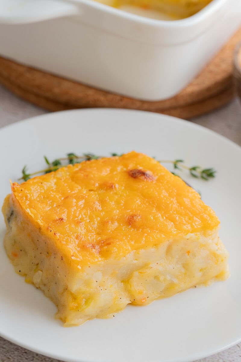 A slice of baked potato pie on a white plate.