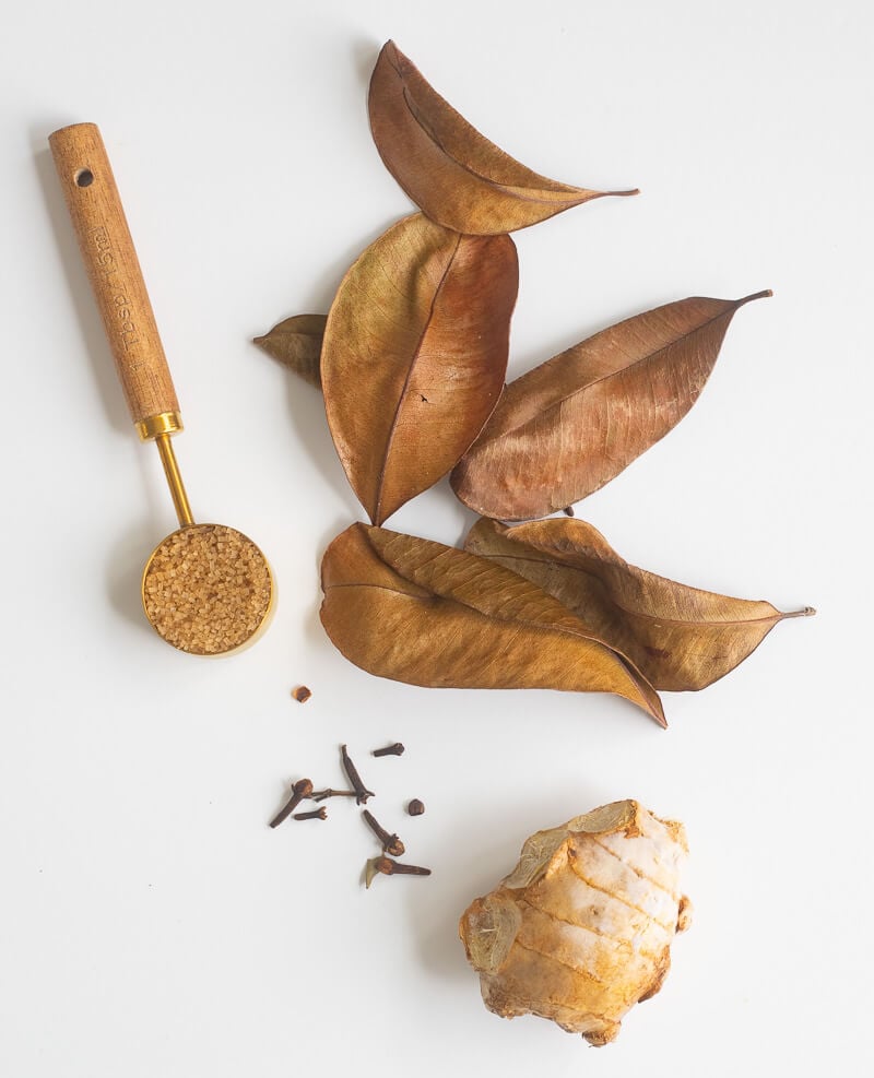 Ingredients for bay leaf tea. Bay leaves, cloves, ginger, and sugar.