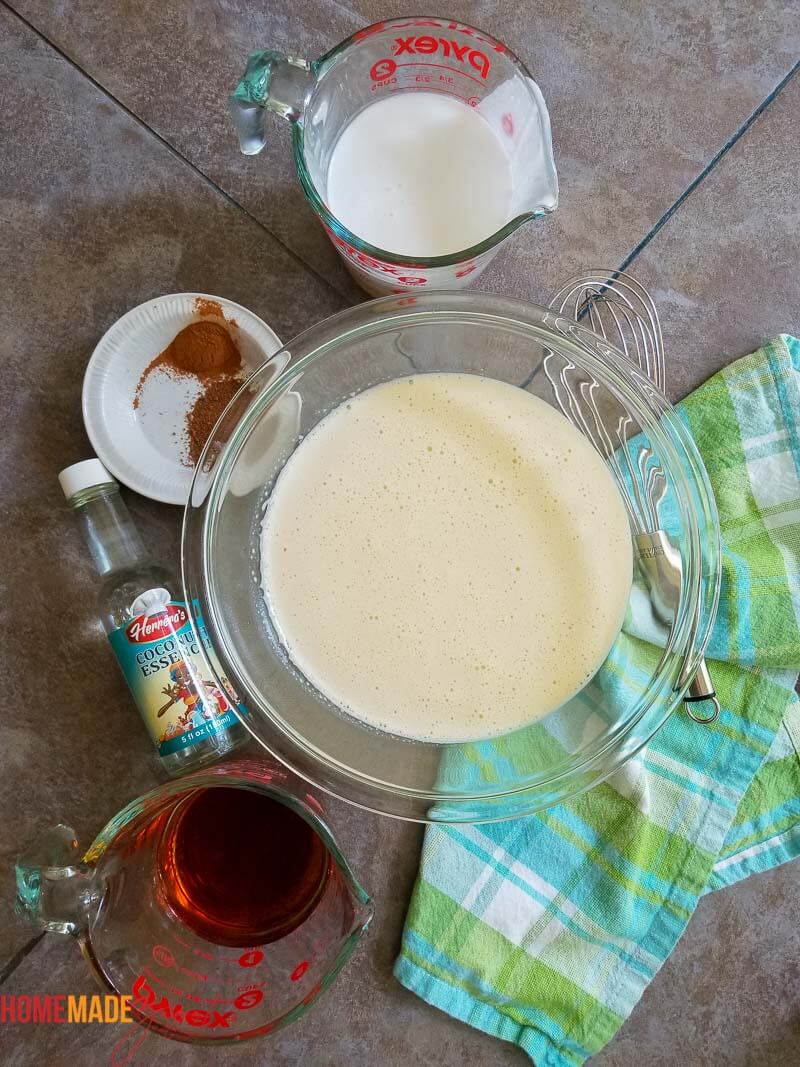 Mixed eggs and condensed milk in a bowl for ponche de creme