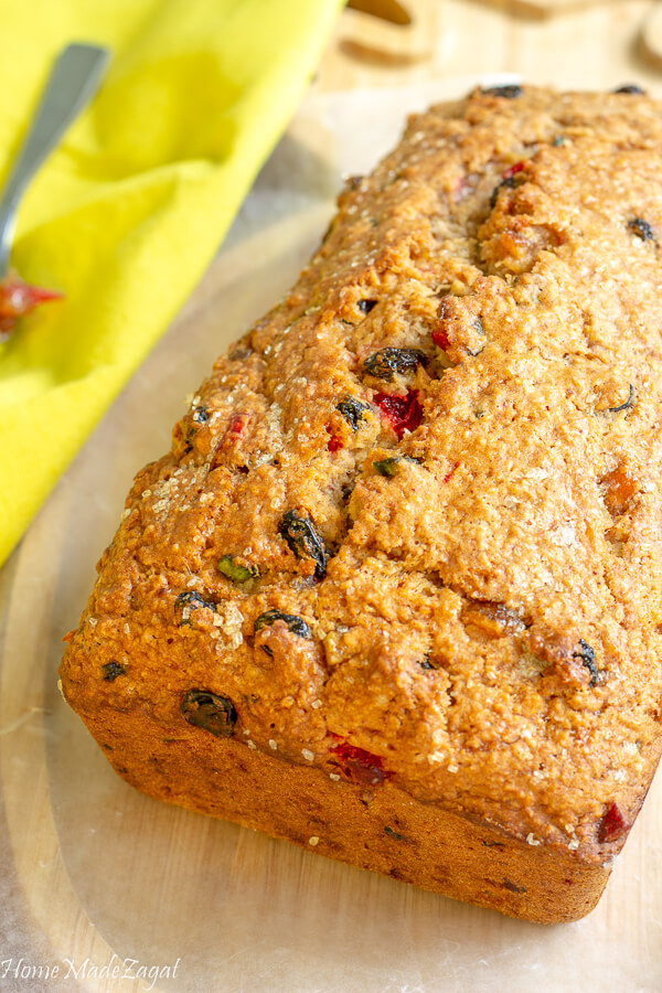 A whole baked loaf of sweet bread on a wooden board