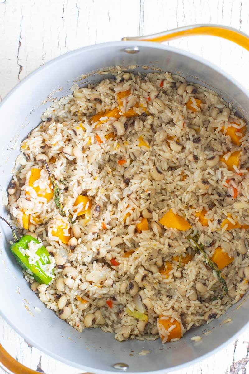 Cooked down black eye peas and rice in a large pot ready to be served,