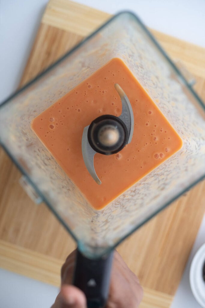Blender with pawpaw and milk blended to make a creamy Caribbean drink.