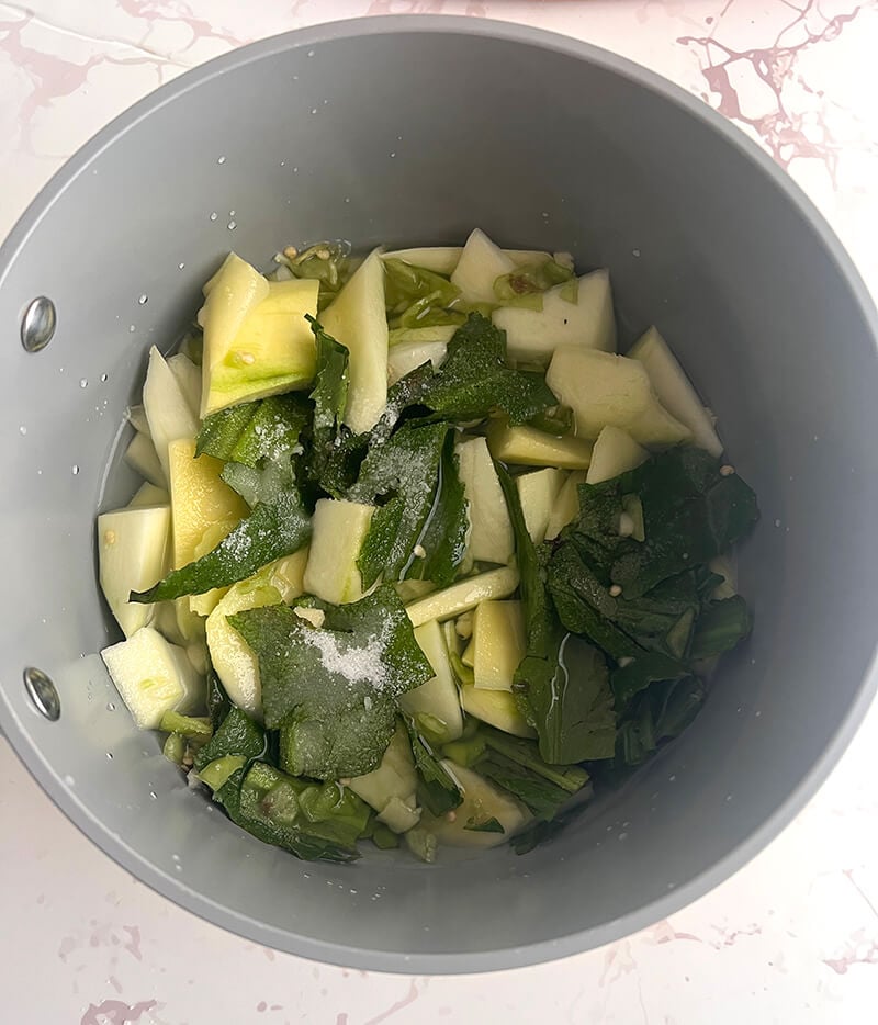 Chopped up ingredients for mango chutney in a pot for the boiling method.