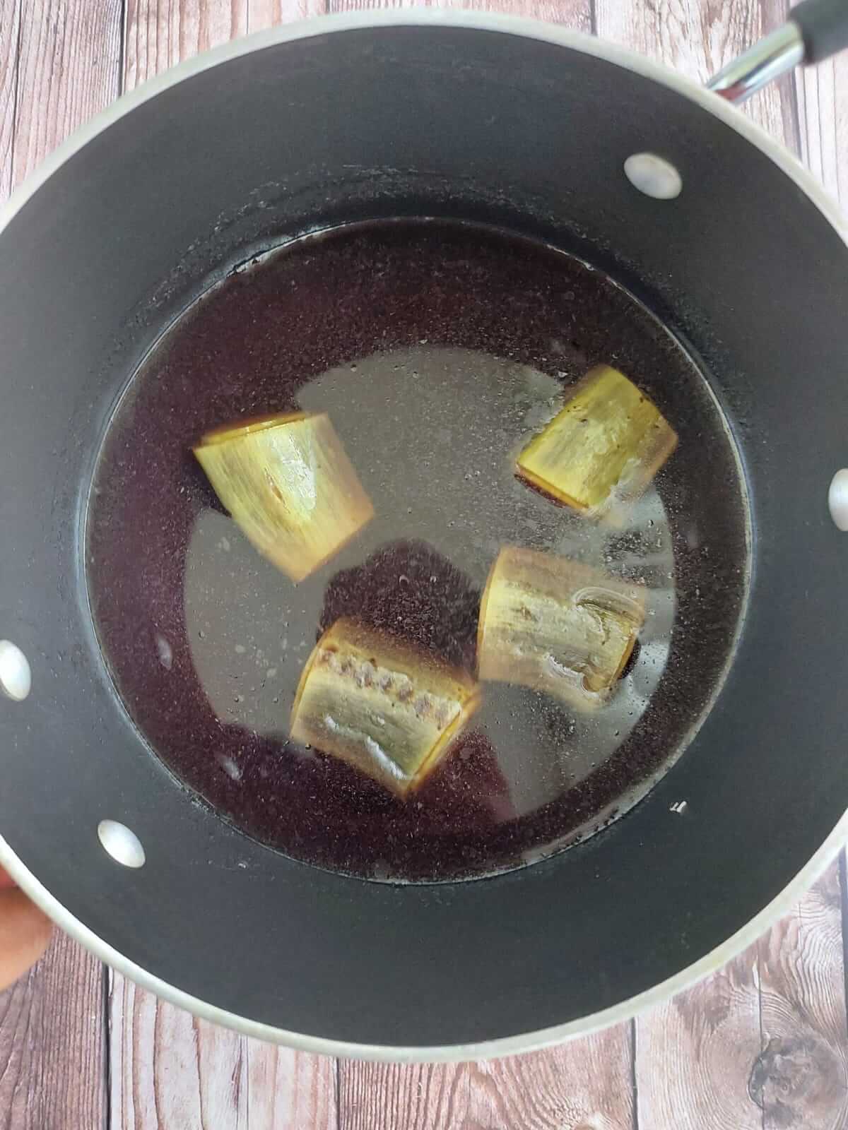 Boiled green plantain sitting in water after boiling.