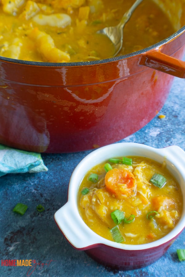 This is a picture of a red mini bowl of caribbean chicken soup