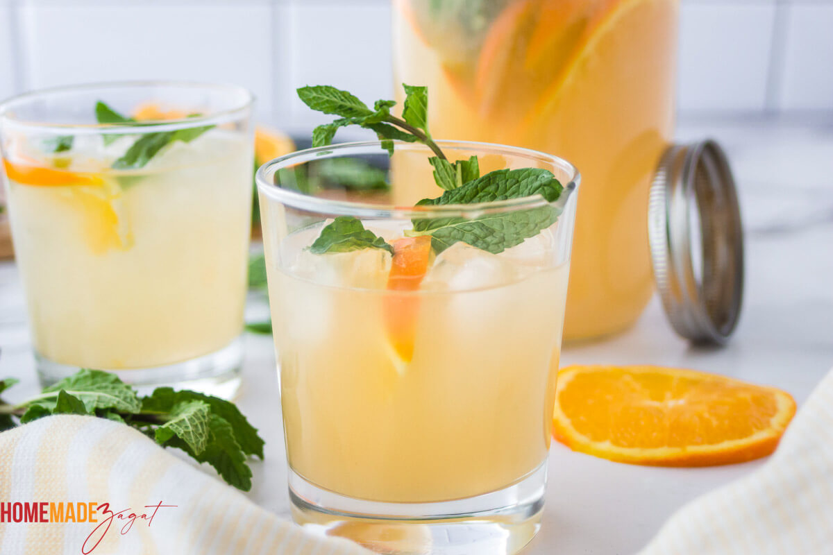 Views of mixed punch in two glasses with ice and mint leaves ready to drink