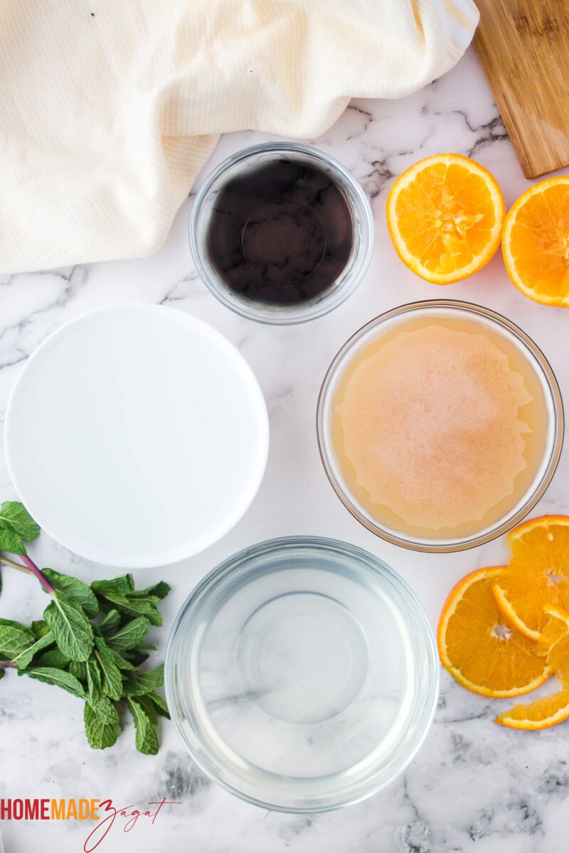 Ingredients for punch in bowls with orange slices