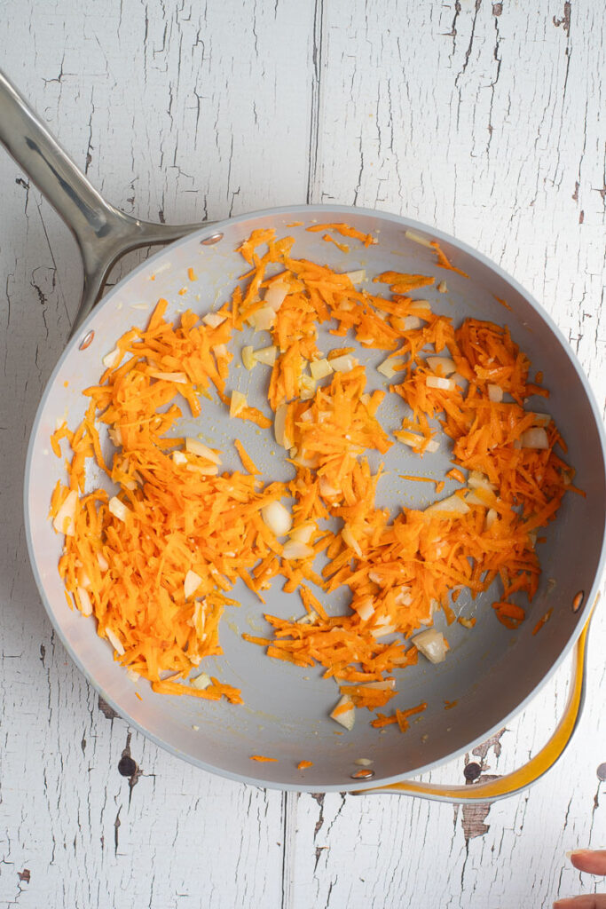 Shredded carrots in melted butter and onion.