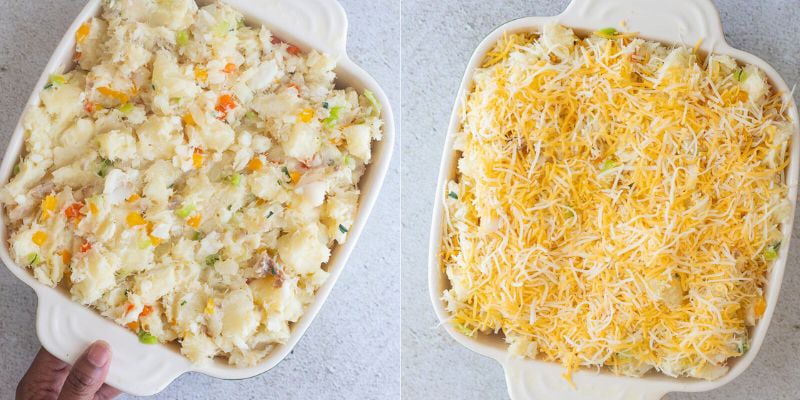 Casssava and fish pie added to baking dish then covered with shredded cheese.