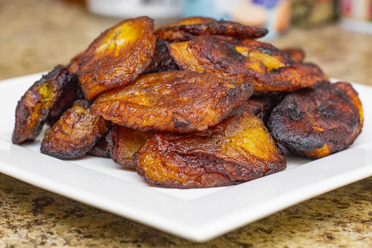 Fried ripe plantains stacked on a plate.