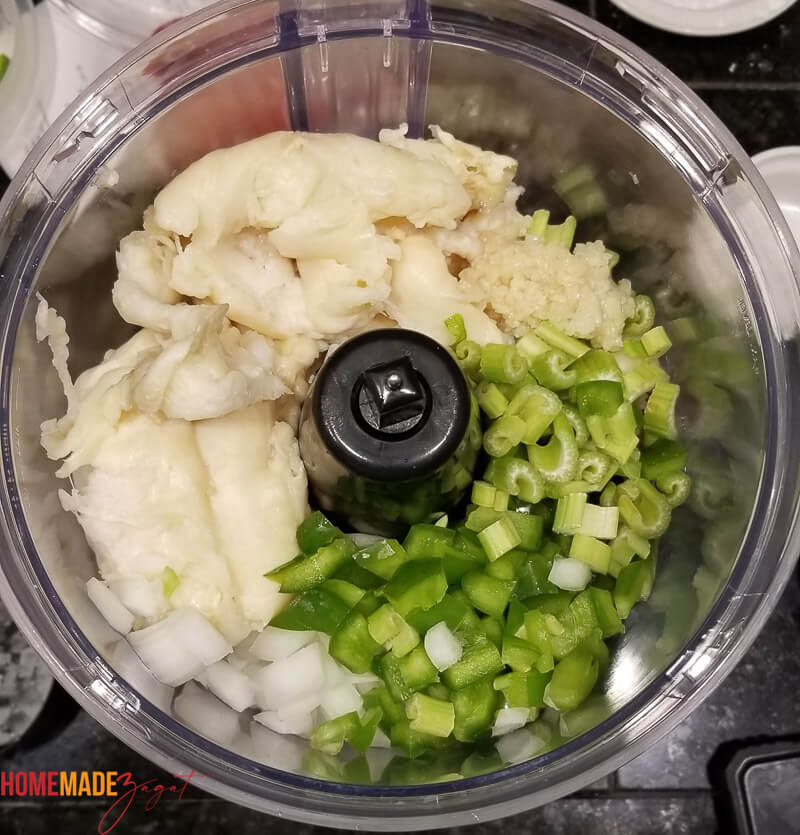 Ingredients in the food processor to make the meat mix: conch, bell peppers, onion, celery, pepper