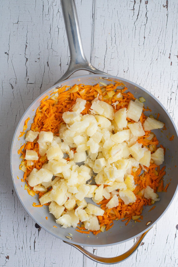 Boiled cassava cubes in carrots and and onions and butter.