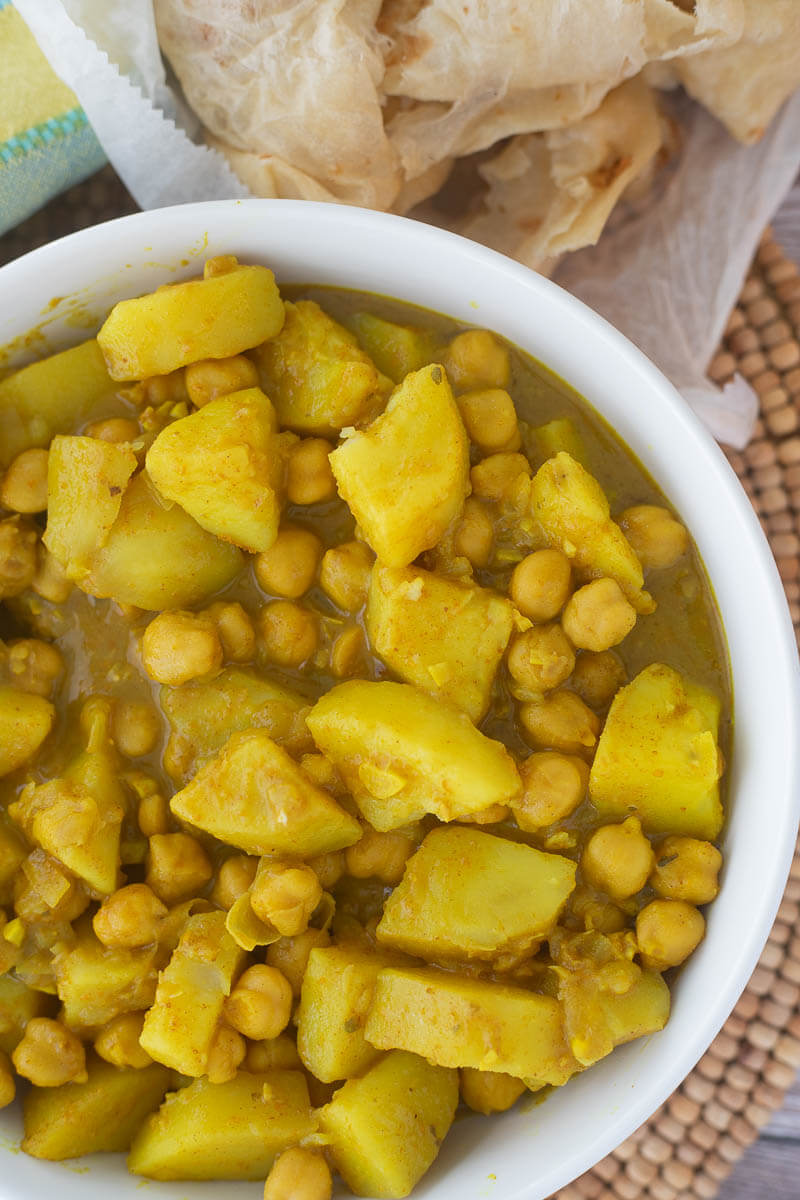 Cooked chickpeas and potato in a curry sauce ready to be served.