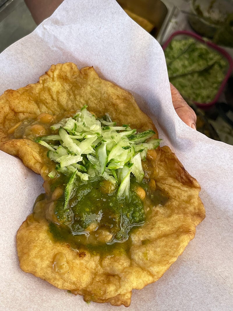 A doubles with chadon beni sauce, tamarind chutney and cucumber chutney.