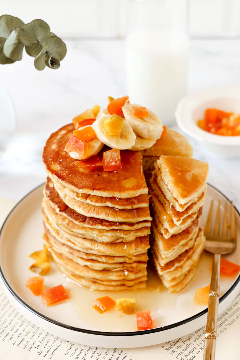 Angled imaged of a stack of cassava pancakes being sliced.